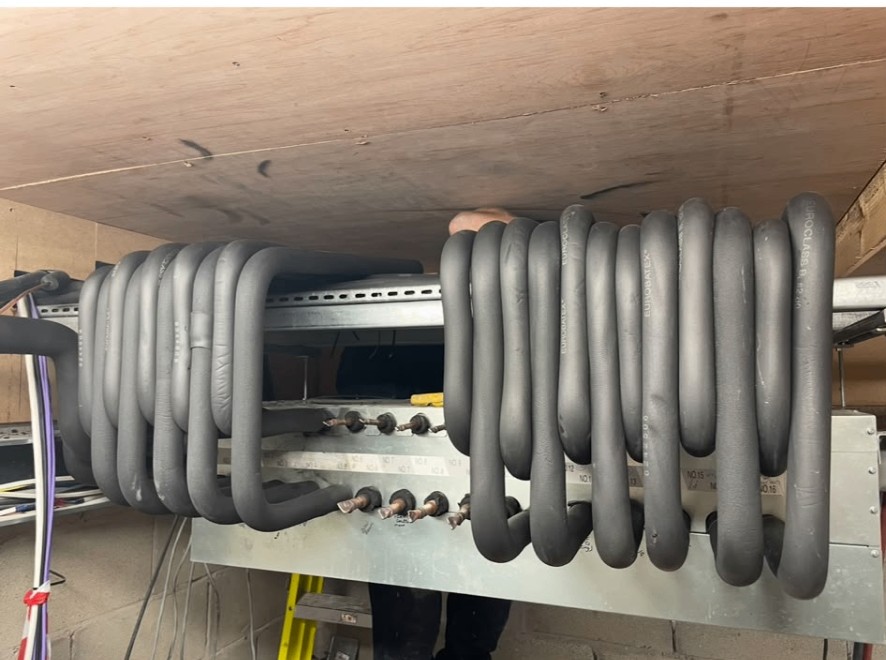 Insulated refrigerant coil pipework on a heat pump installation by JC Heating and Cooling in Preston, Ashton on Ribble.